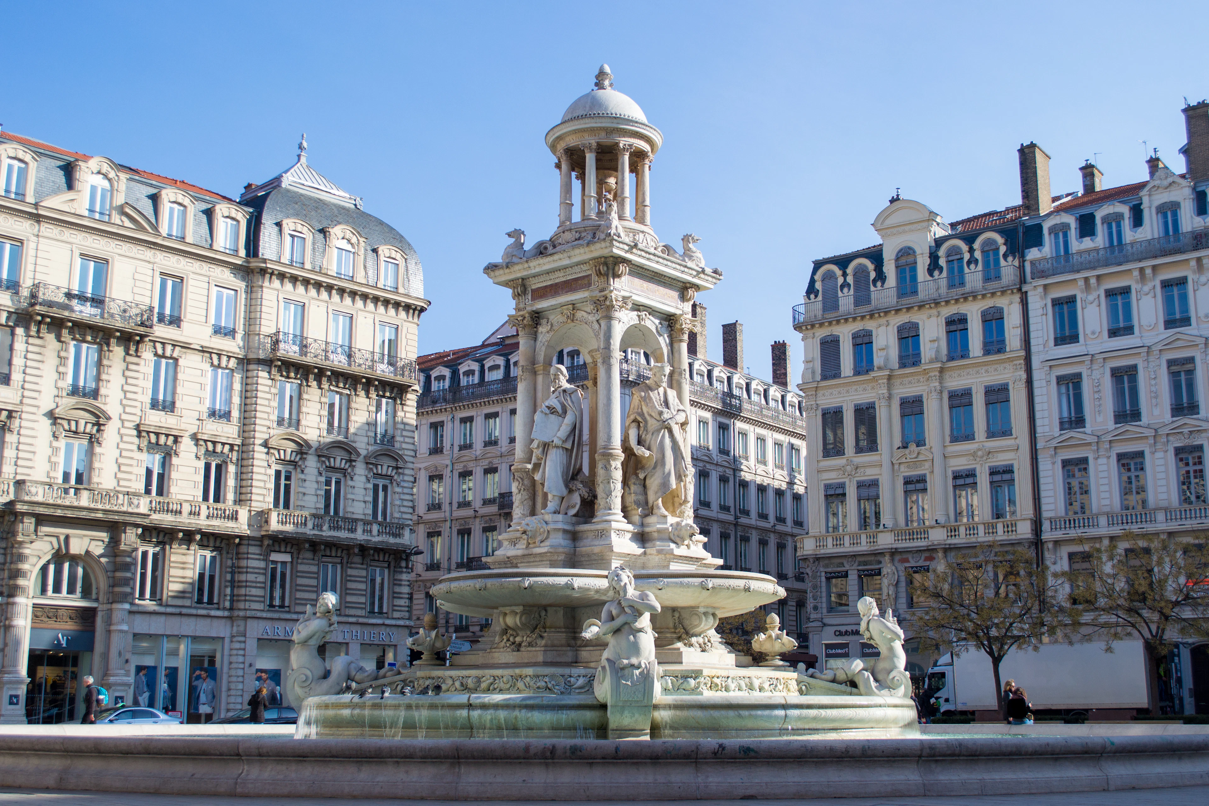 The tiered marble fountain of Place des Jacobins surrounded by elegant nineteenth-century facades in Lyon's Presqu'ile