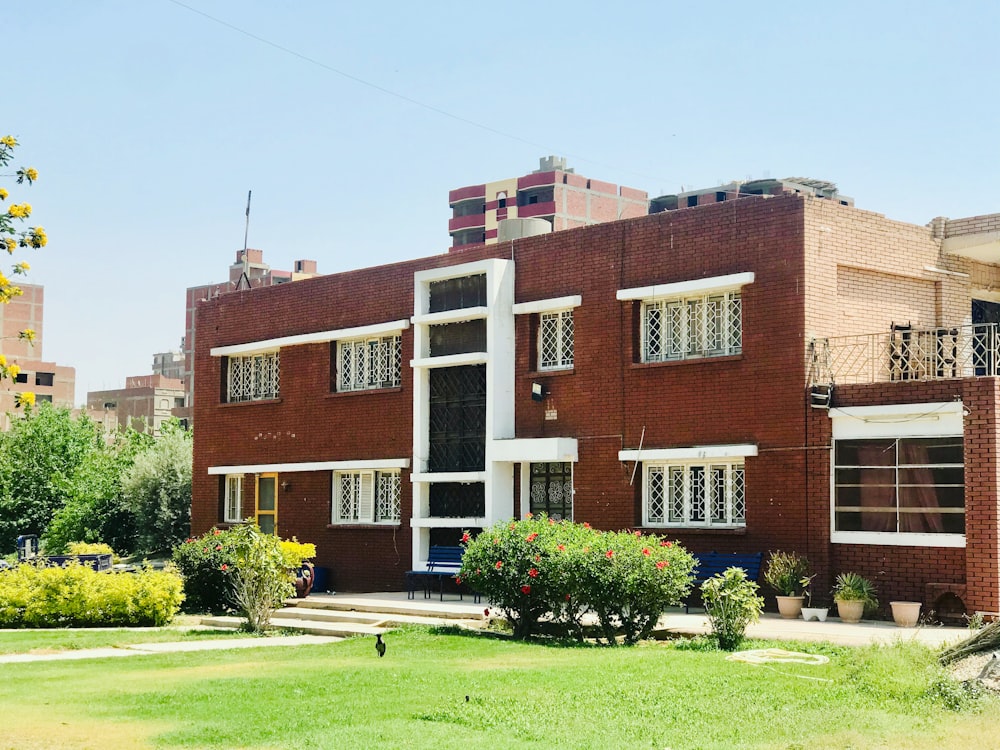 brown concrete building near green grass field during daytime