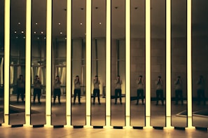 Contemporary art installation featuring light and shadow in a minimalist room