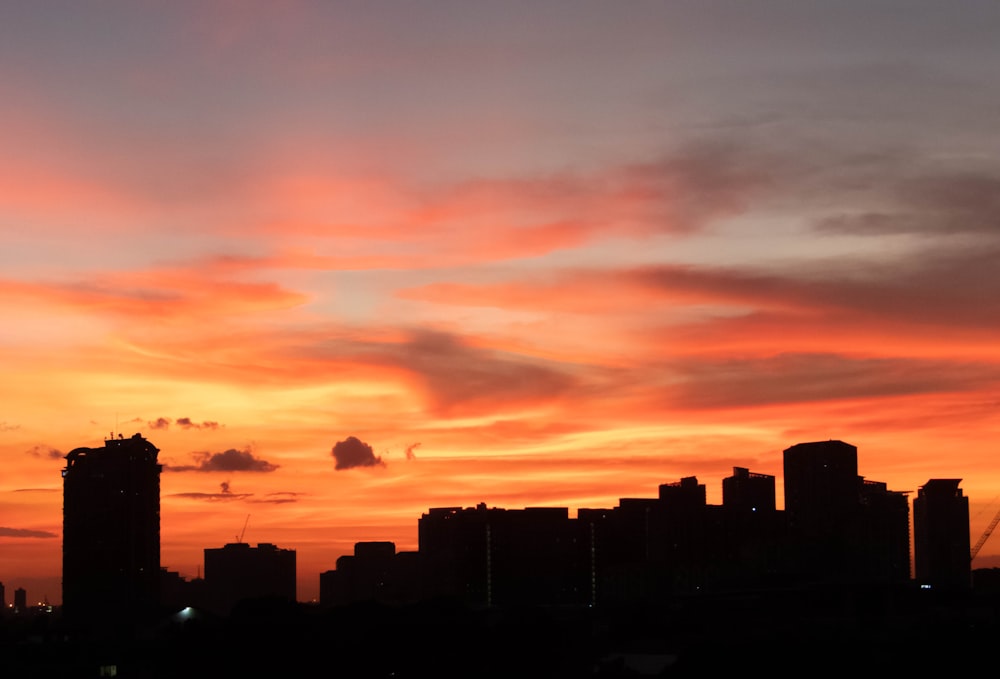 silhouette of city buildings during sunset