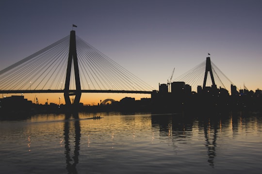 silhouette of bridge during sunset in ANZAC Bridge Australia