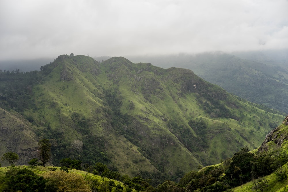 green mountains under white clouds during daytime