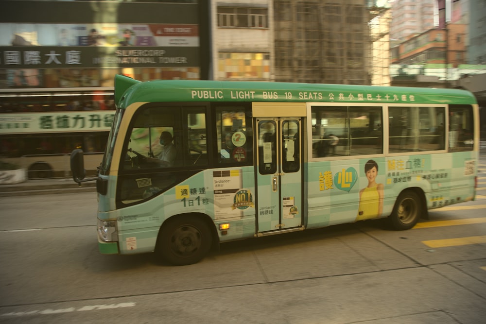 bus vert et blanc sur la route pendant la journée