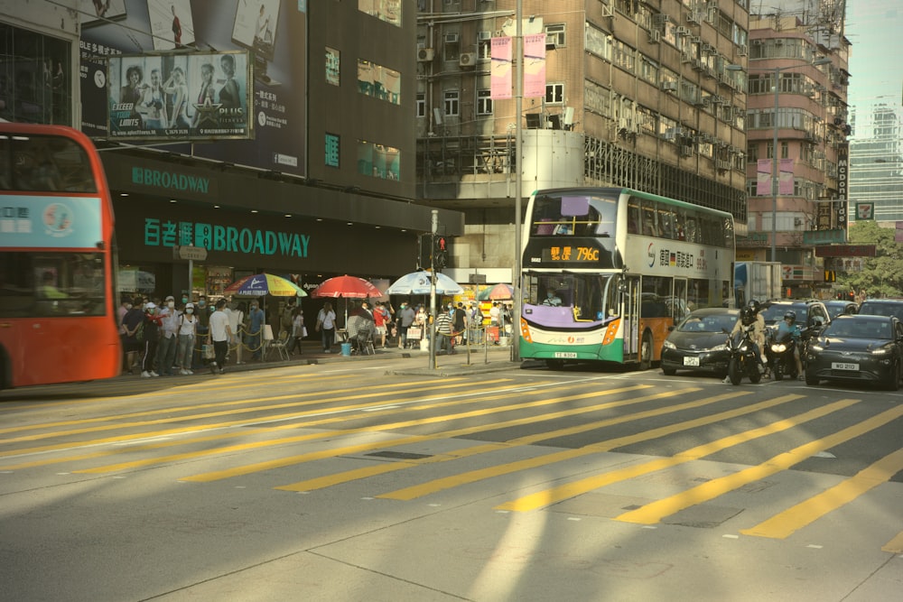 people riding on green and blue tram during daytime