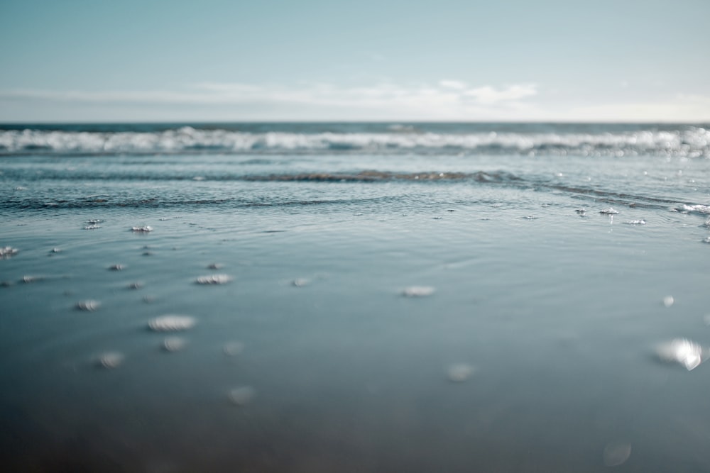 water waves on the shore during daytime