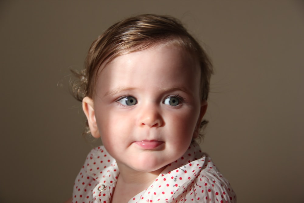 girl in white and red polka dot shirt