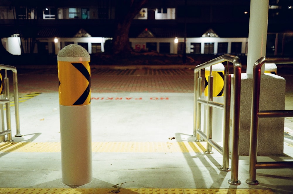 white and yellow metal post