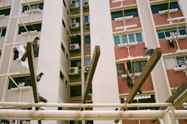 Wide shot of a residential building in Jalahalli protected by neatly installed pigeon nets.