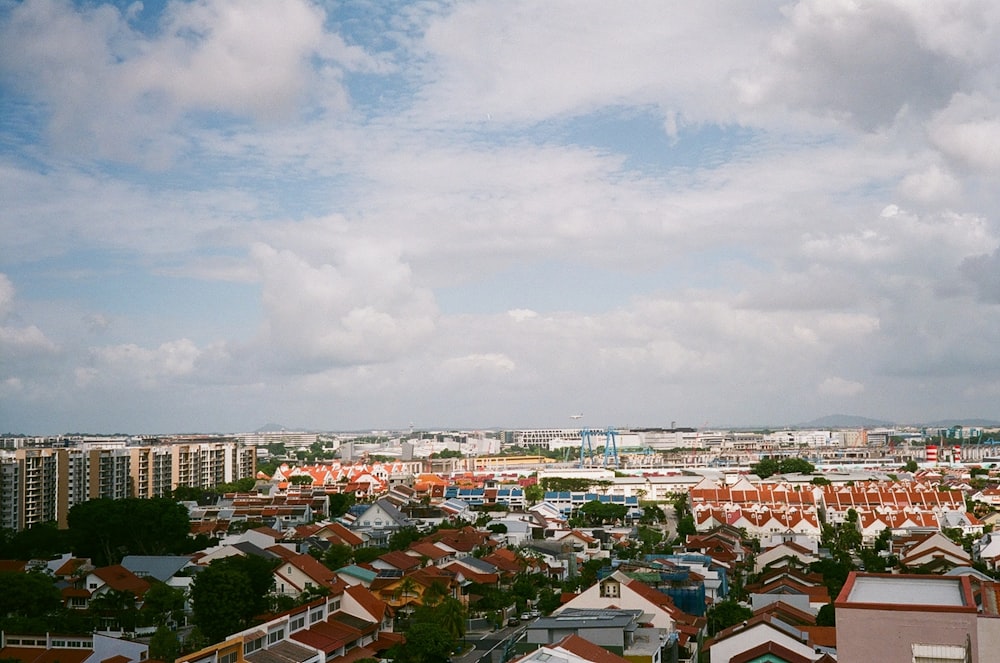 city with high rise buildings under white clouds during daytime