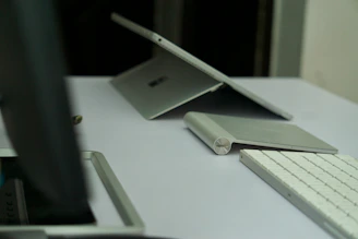 A sleek workspace featuring AI tools on a laptop surrounded by navy and silver office accessories.