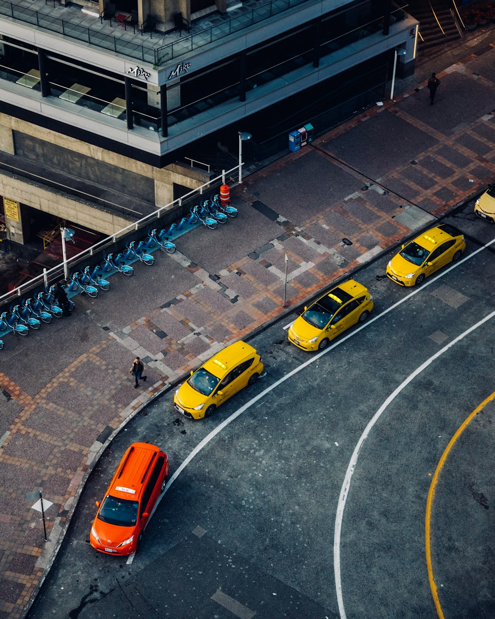 yellow taxi on road during daytime