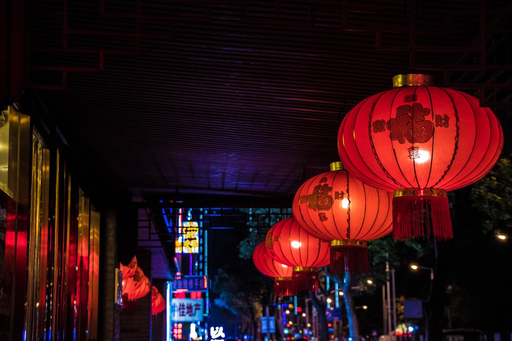 red paper lanterns on street during nighttime