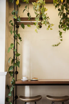 A cozy corner with a simple wooden table, a plant, and a cup of tea reflecting calm home vibes.