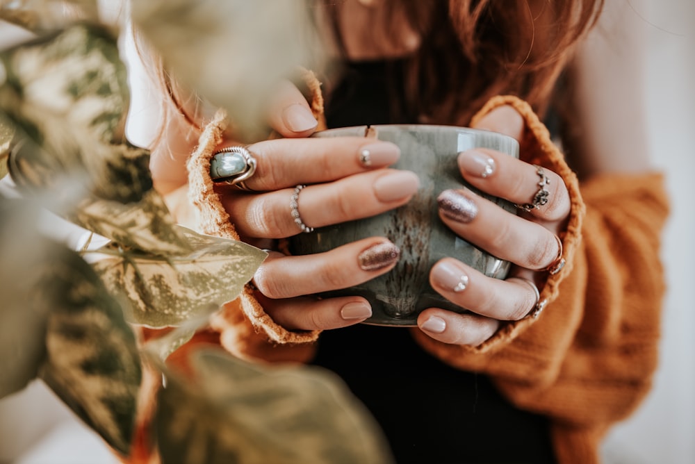 person holding silver round coin