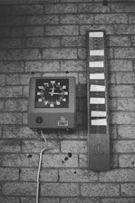black and white analog wall clock at 10 00
