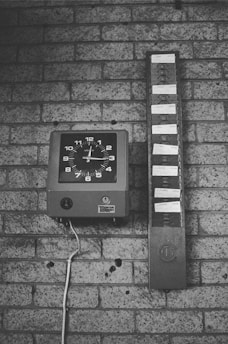 black and white analog wall clock at 10 00