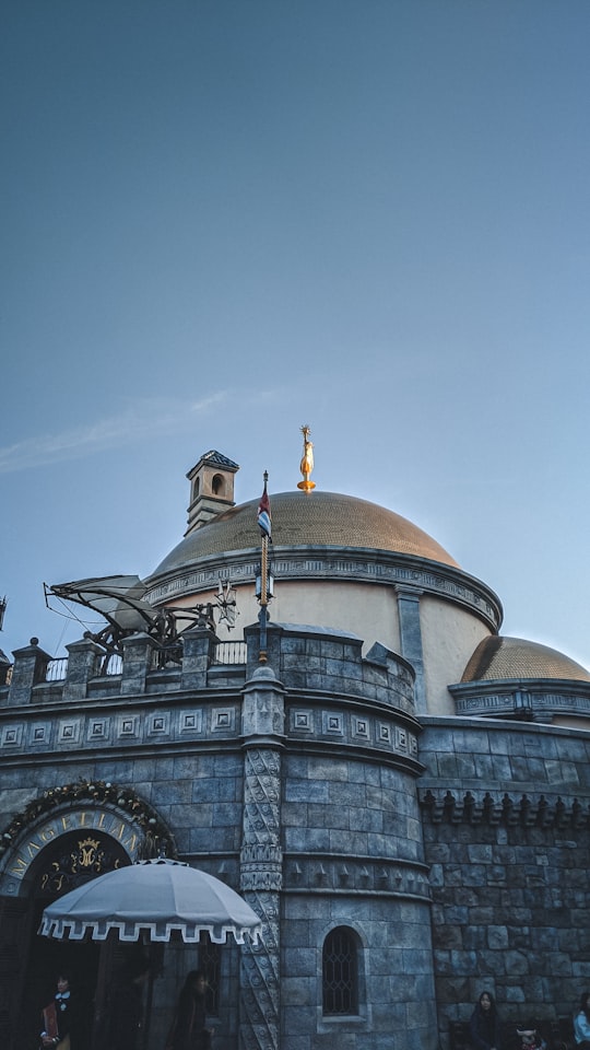 brown and gray concrete dome building under blue sky during daytime in Tokyo DisneySea Japan