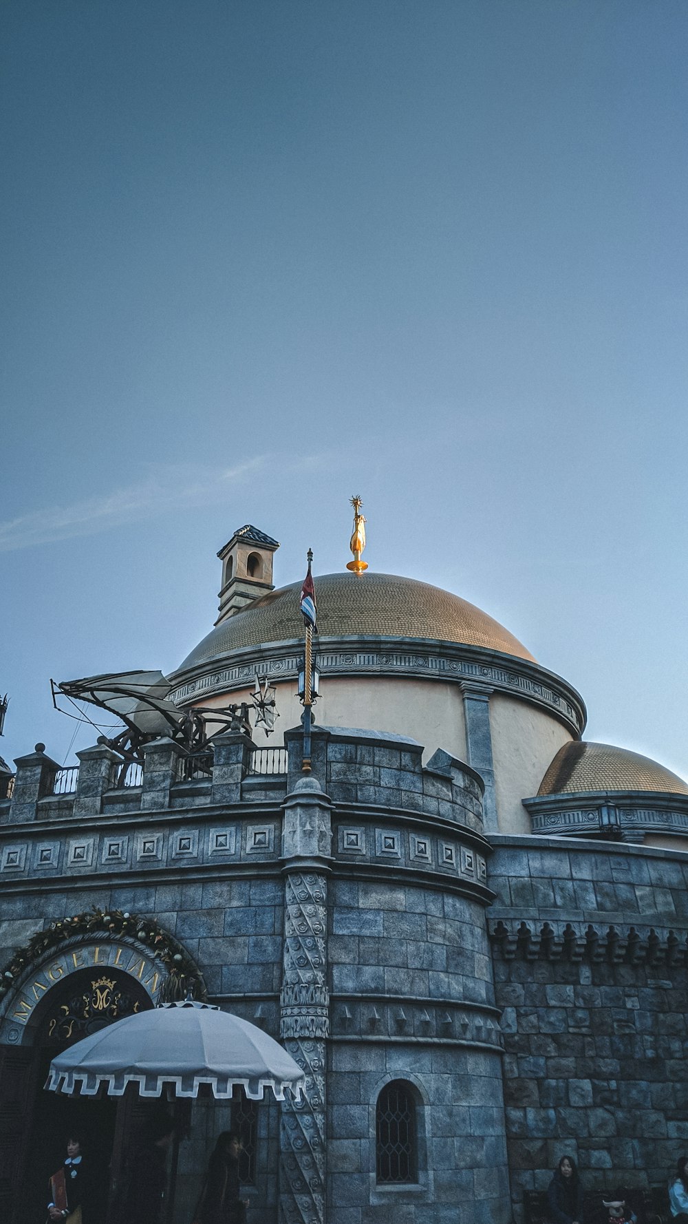 brown and gray concrete dome building under blue sky during daytime