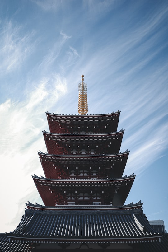 red and black tower under blue sky during daytime in Sensō-ji Japan