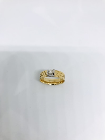 gold ring on white table