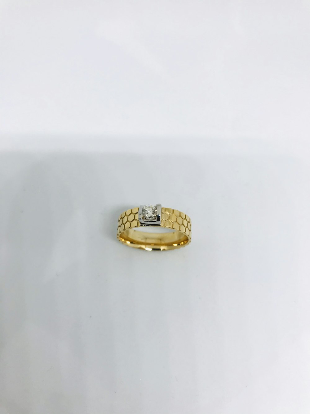 gold ring on white table