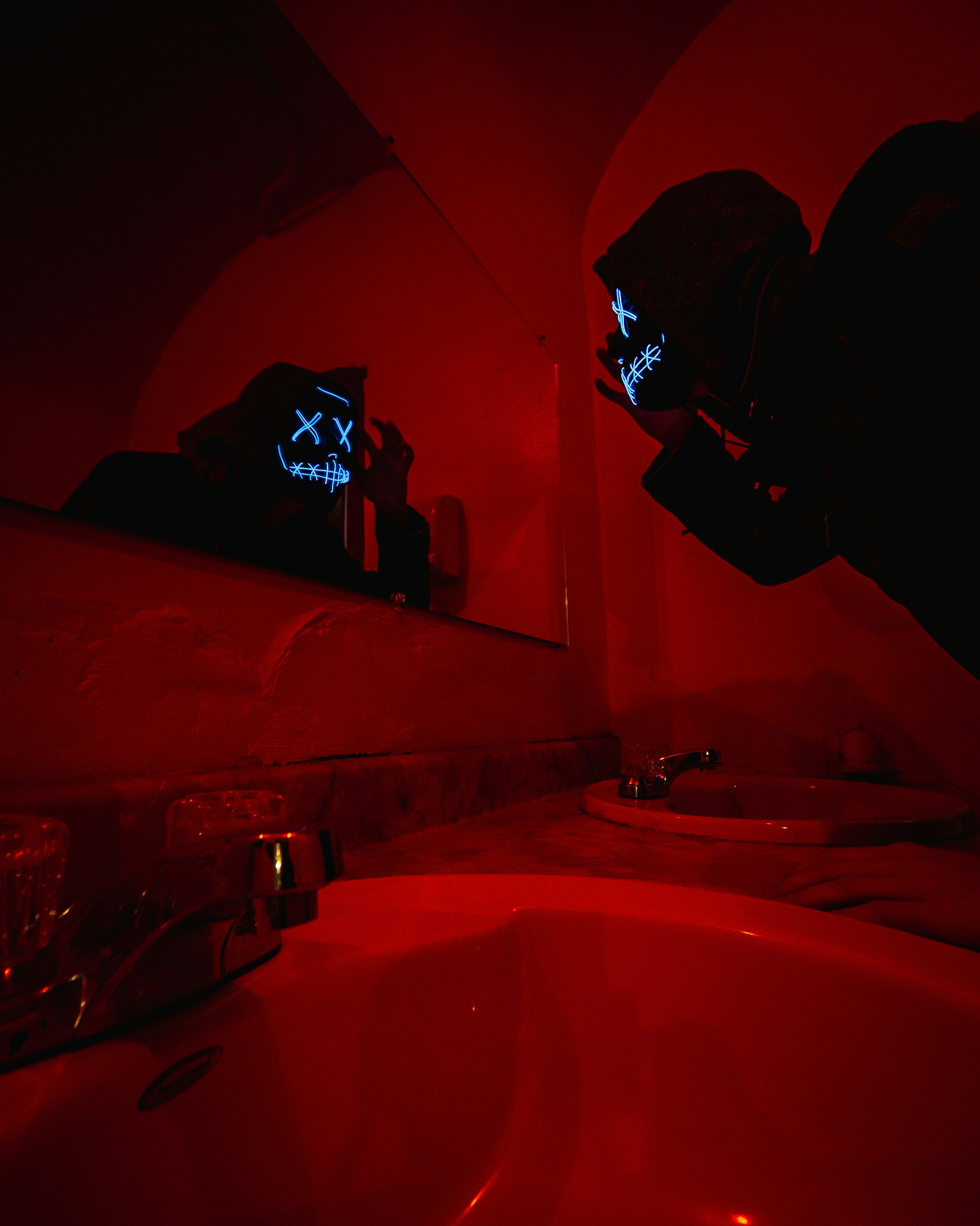 person in black jacket standing in front of mirror