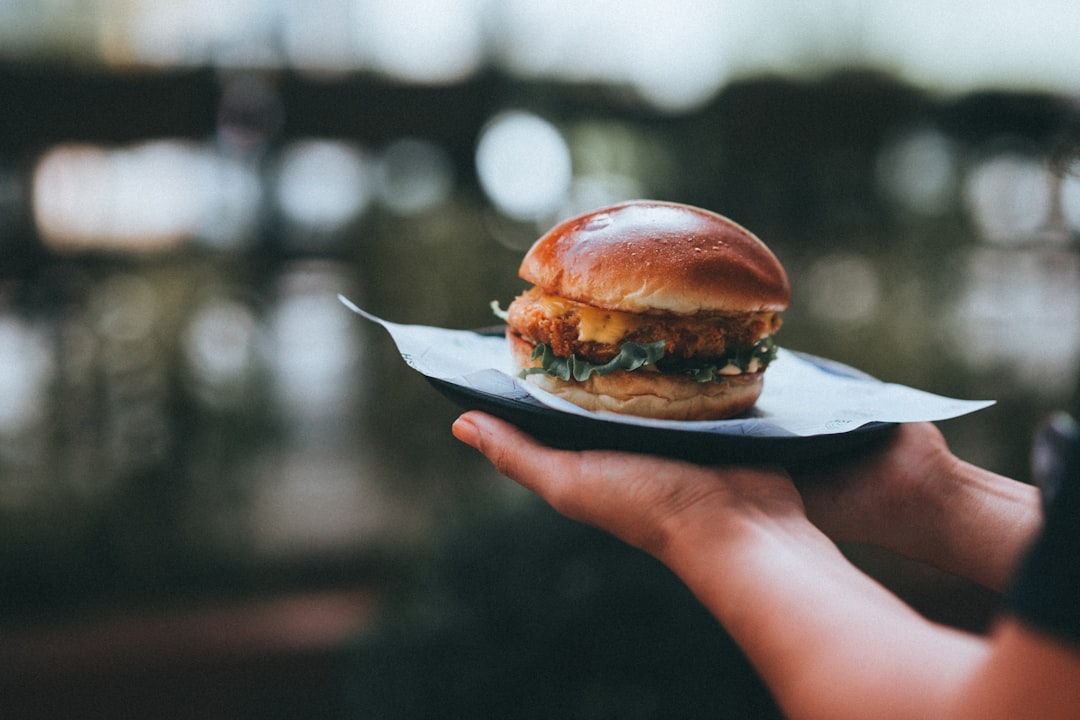 burger on white paper plate