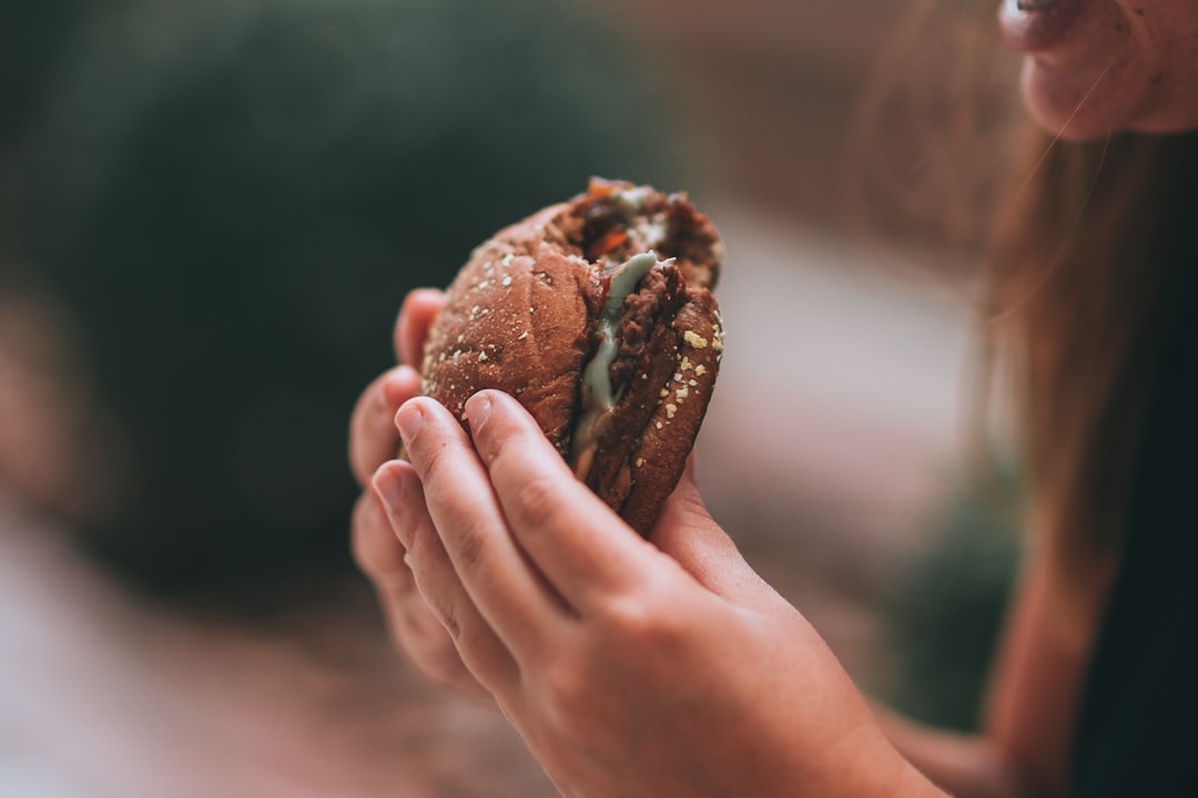 person holding brown bread with chocolate filling