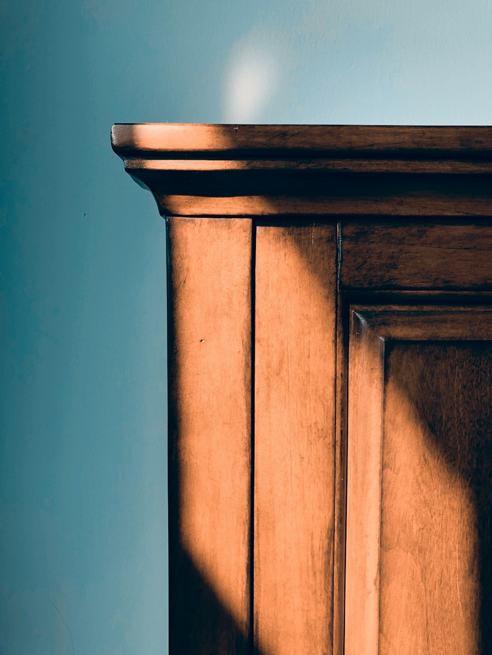 brown wooden cabinet on white wall