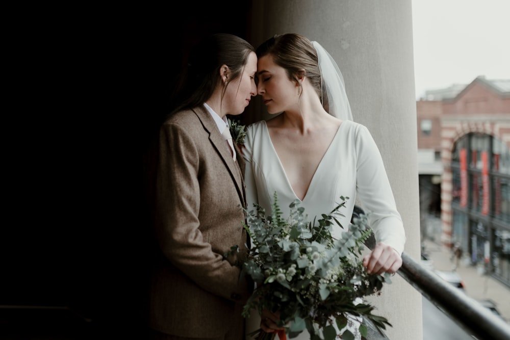 man and woman holding bouquet of flowers