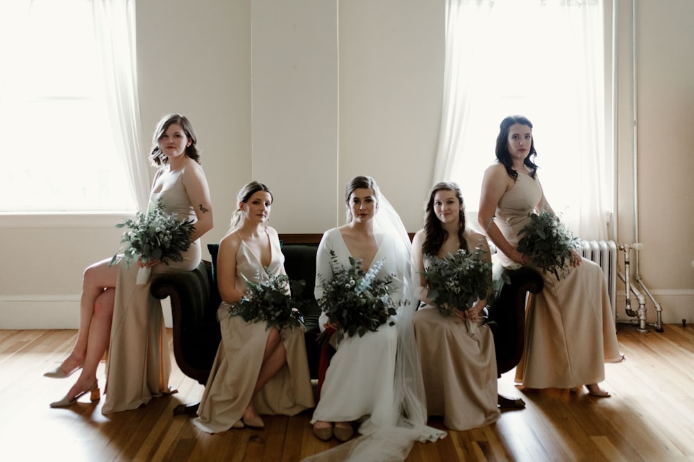 woman in white wedding gown holding bouquet of flowers