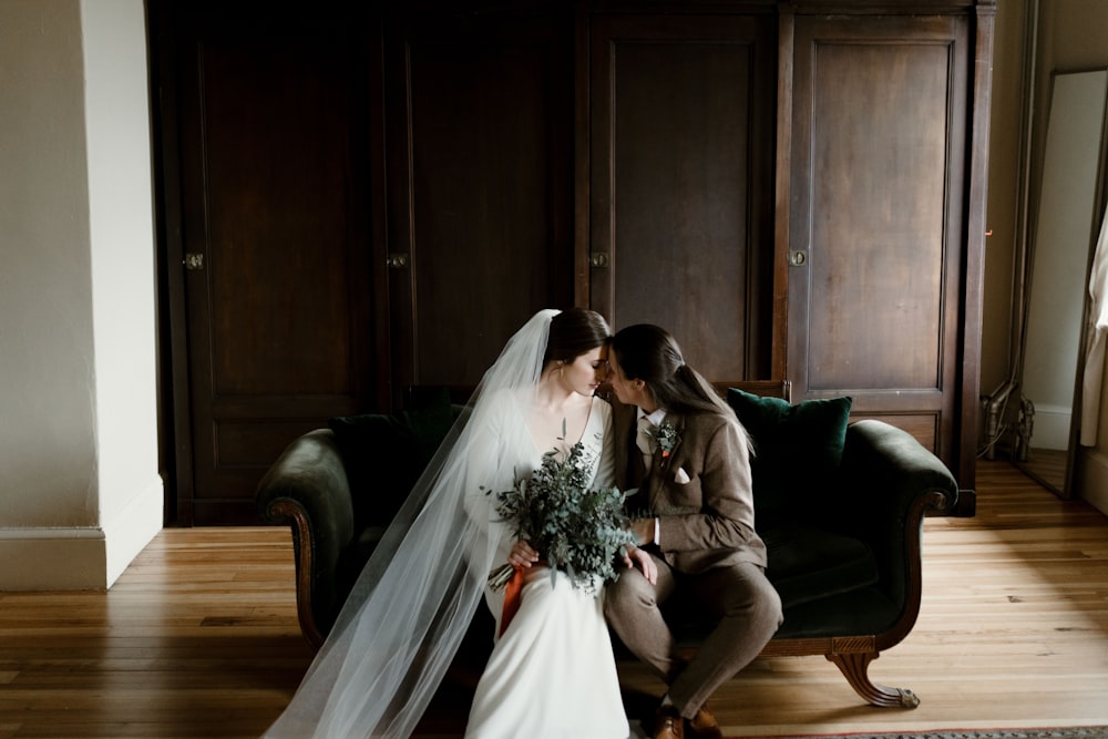 bride and groom sitting on green couch