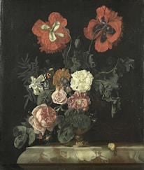 A still life painting featuring a rich arrangement of various flowers, including large red poppies and white roses, displayed in a decorative vase. The composition is enhanced by green foliage and accented by a butterfly and a small snail on a marble ledge. The background is dark, highlighting the vibrant colors of the flowers.