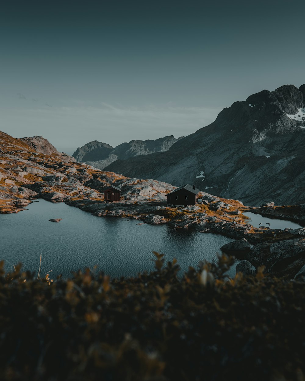 brown and white mountains near body of water during daytime