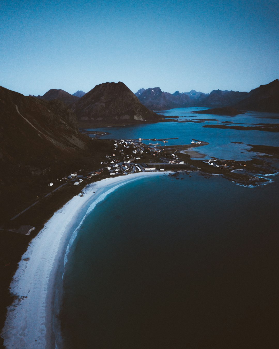 body of water near mountain during daytime