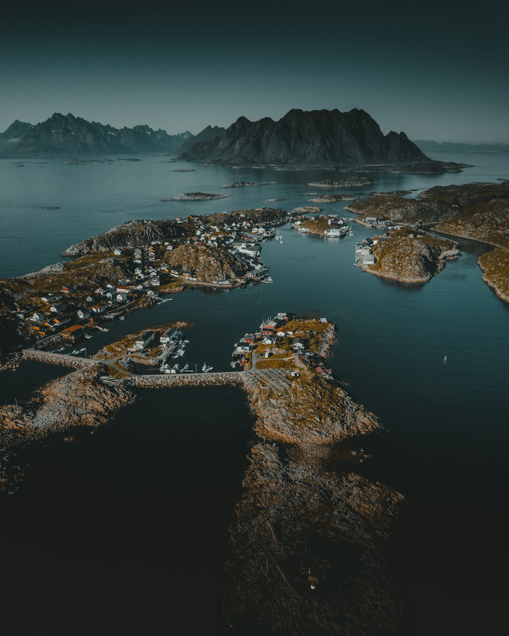 brown and white mountain beside body of water during daytime