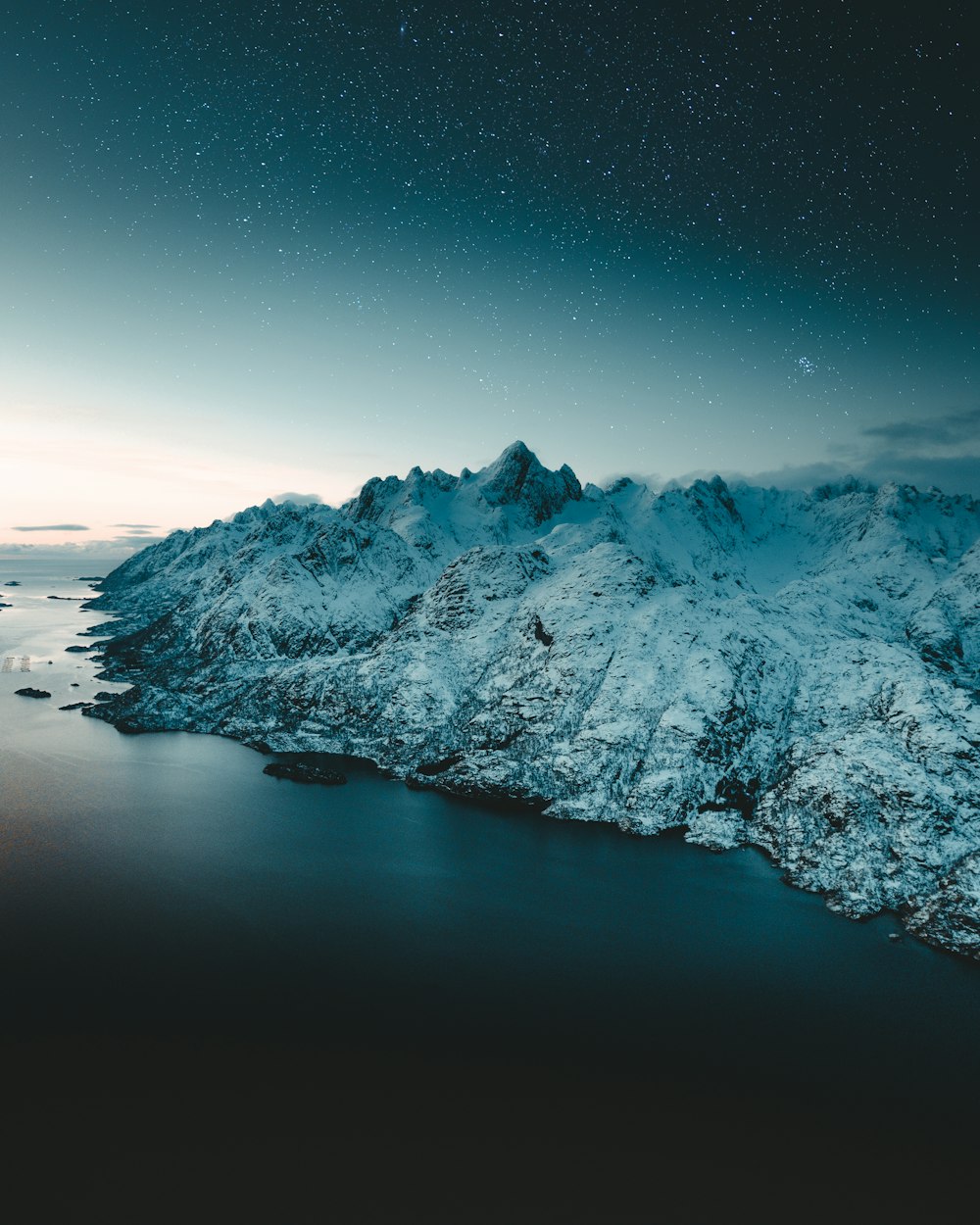 snow covered mountain during night time