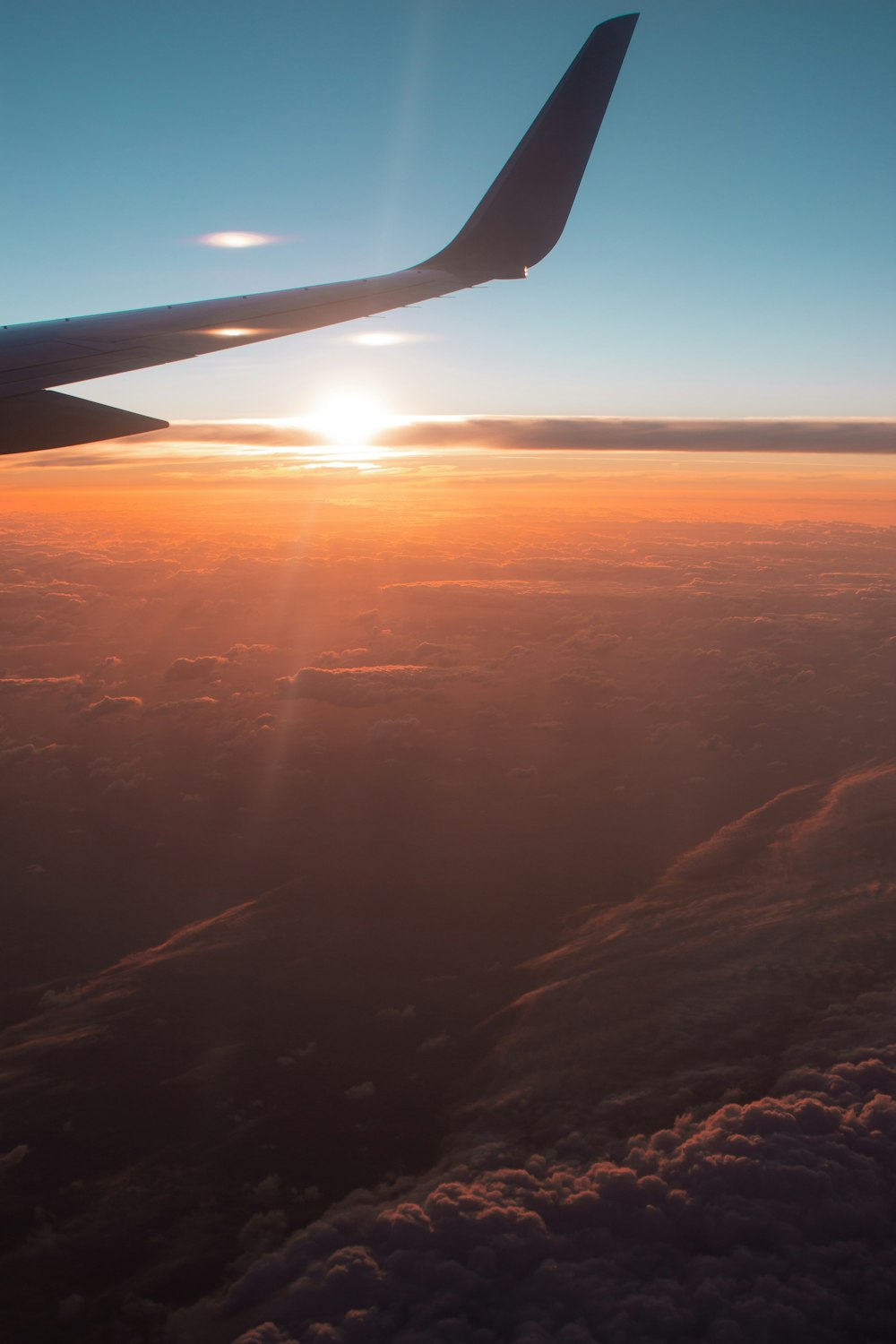 sun setting over the clouds