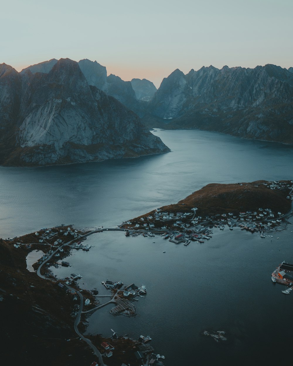 brown and green mountains beside body of water during daytime