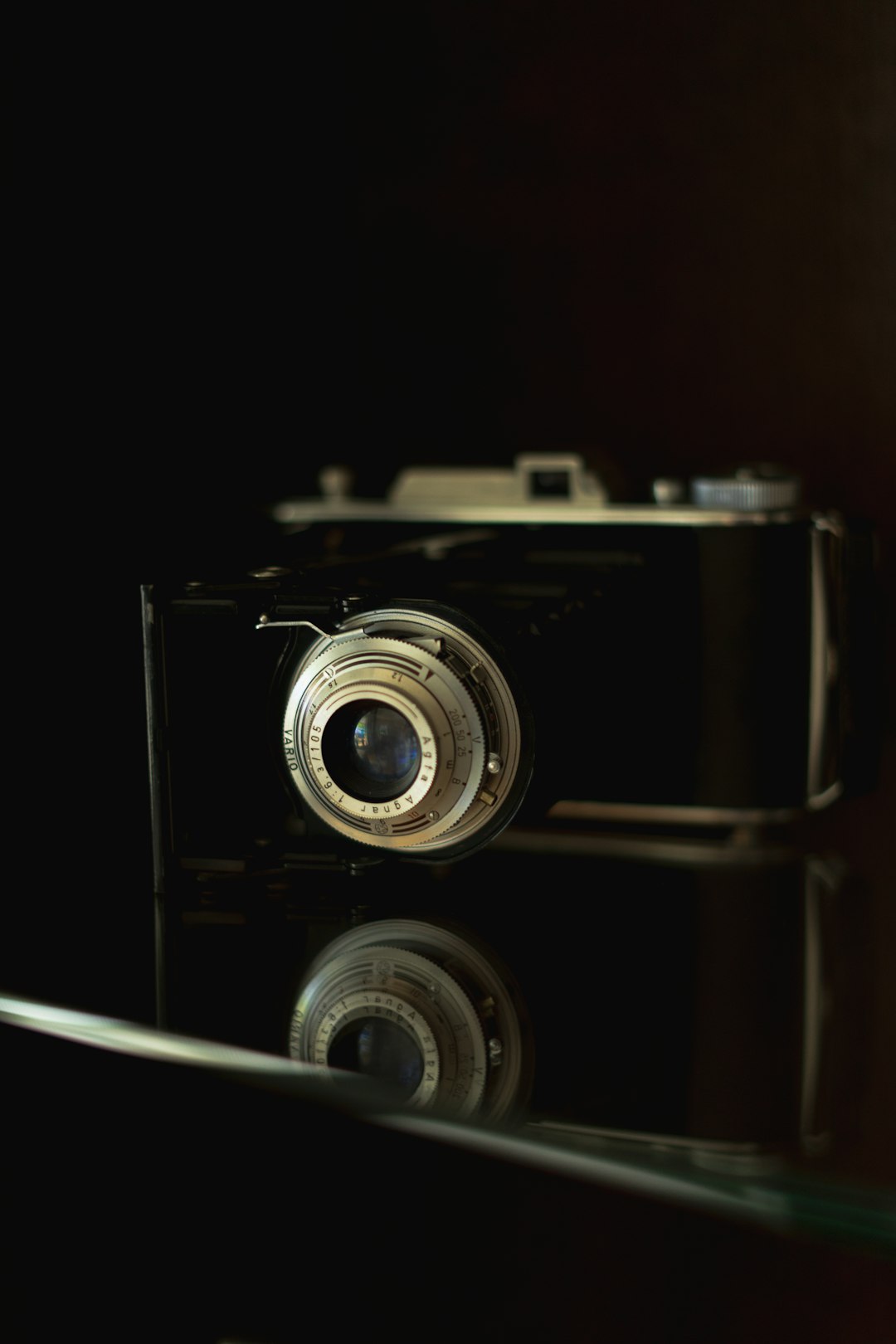 black and silver camera on white surface