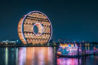 ferris wheel near body of water during night time
