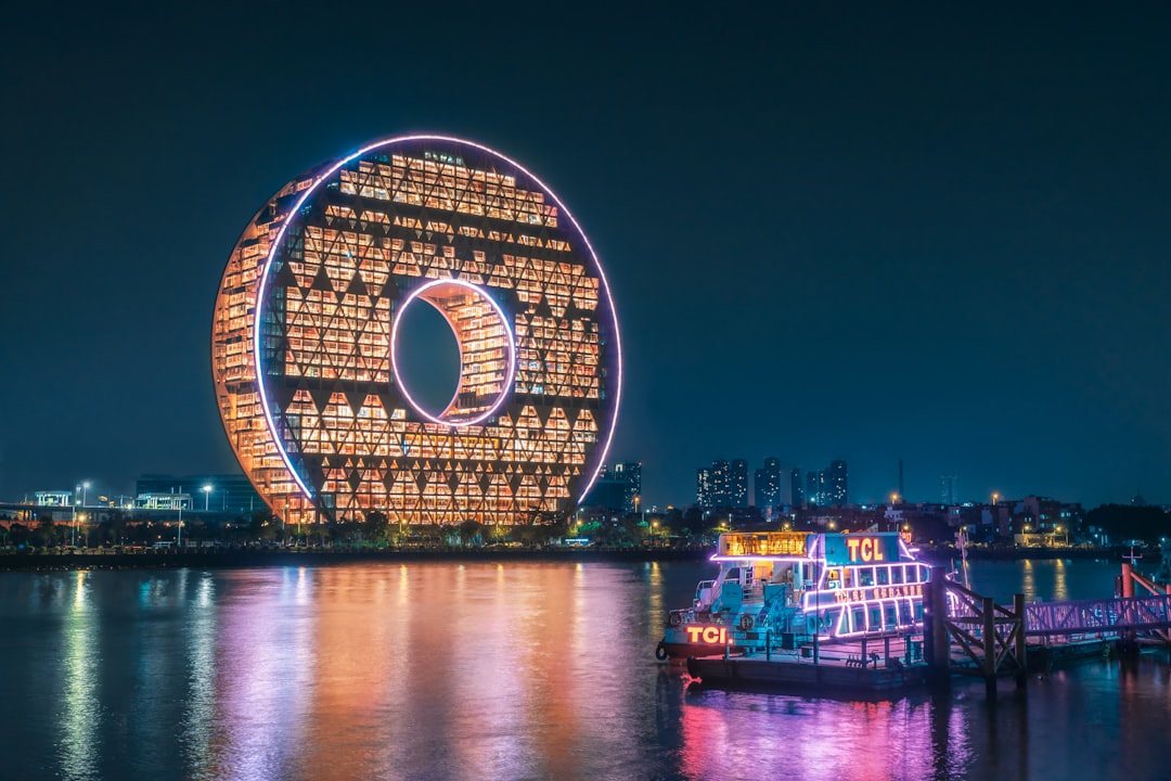 ferris wheel near body of water during night time