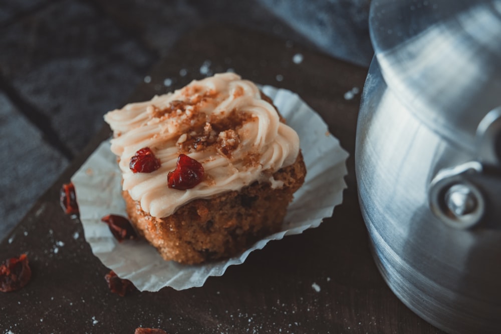 brown and white cupcake with white icing on top