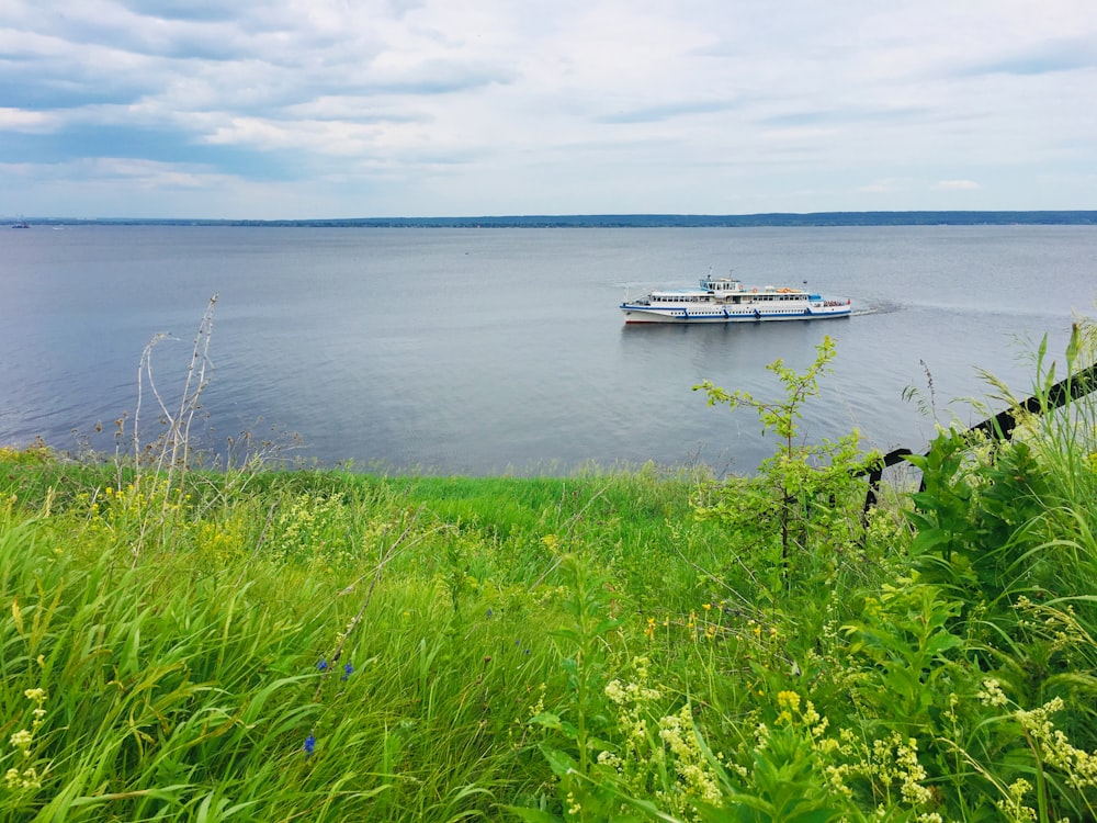 white boat on sea during daytime