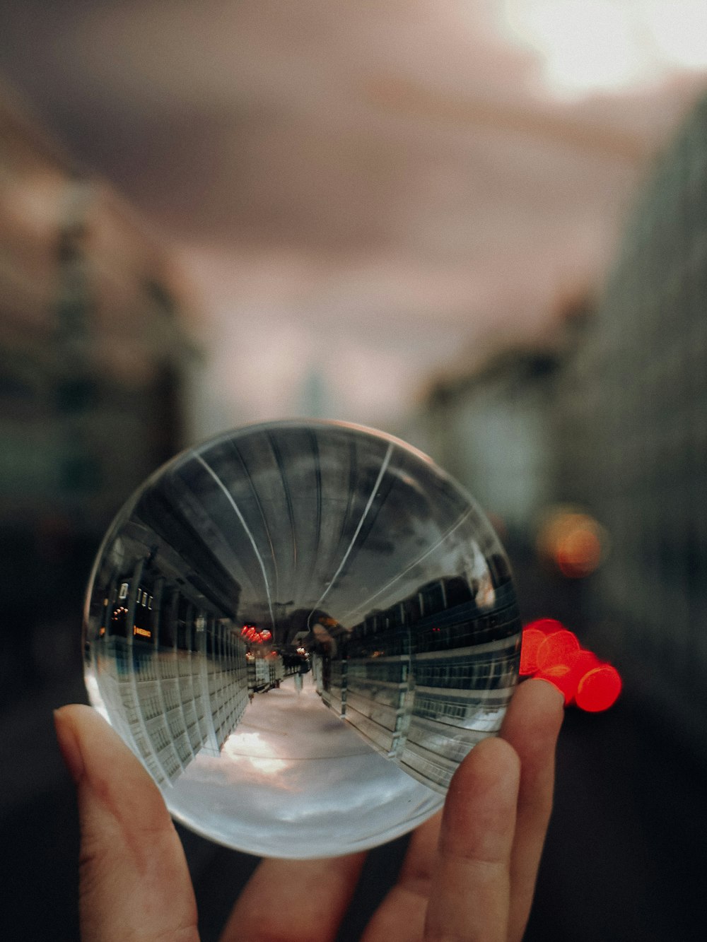 person holding clear glass ball