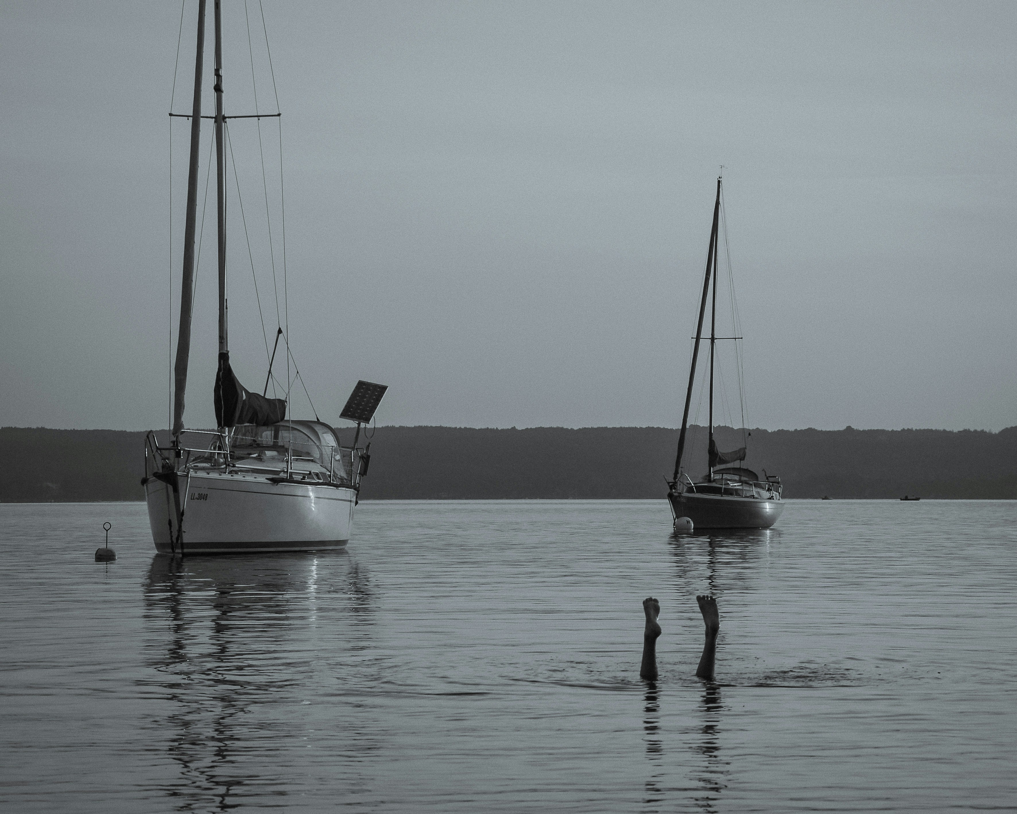 white sail boat on sea during daytime