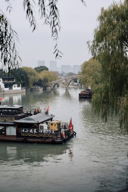 Peaceful riverside scenery in Jieyang with traditional boats floating gently.