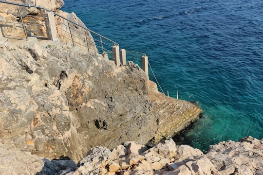 brown rock formation near body of water during daytime in Dobra Voda Montenegro