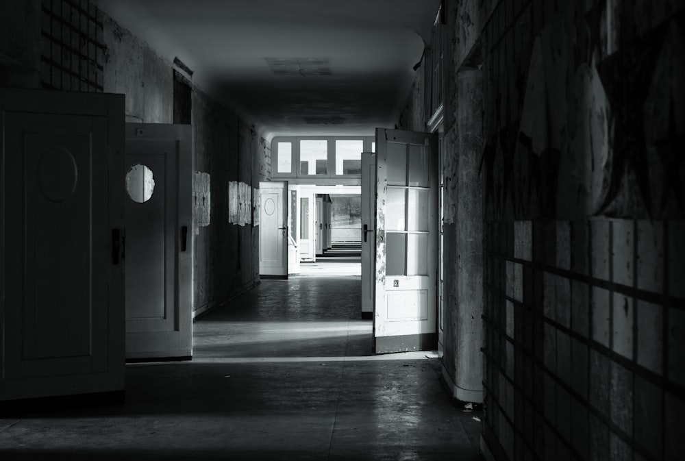 grayscale photo of hallway with doors