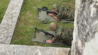 Security personnel conducting tactical training exercises in a rugged outdoor environment.